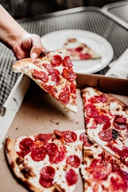 sliced pizza on white ceramic plate