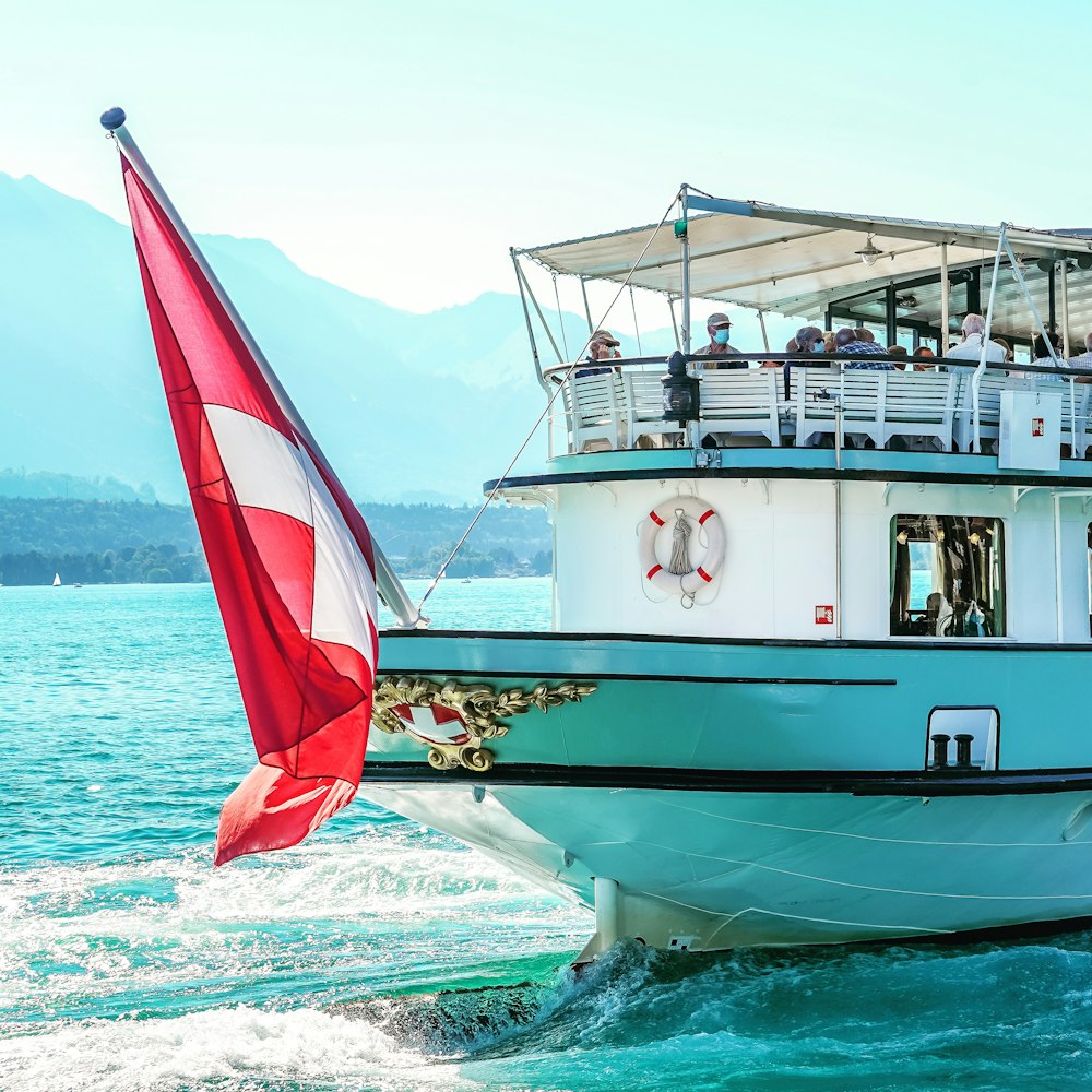 white and red boat on sea during daytime