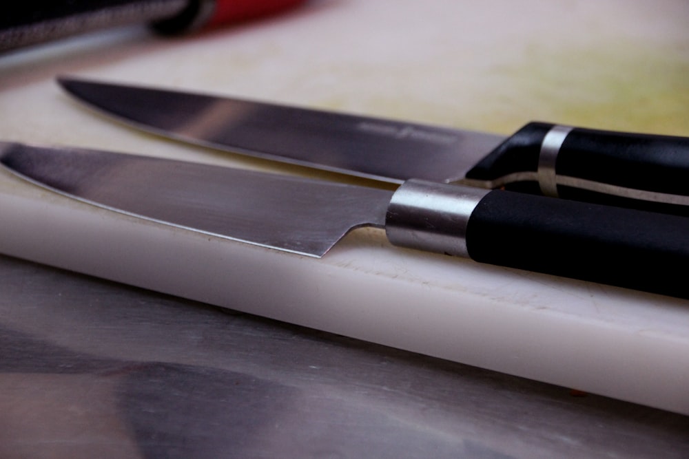 silver and black knife on silver table