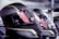 A close-up view of several high-tech motorcycle helmets arranged in a row. The helmets feature a sleek, aerodynamic design with a combination of glossy black and reflective yellow patterns. The visors have warning stickers indicating anti-scratch features, with text and symbols visible upon inspection.
