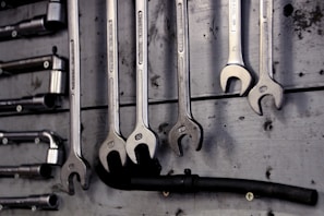 A collection of plumbing tools neatly arranged on a workbench.
