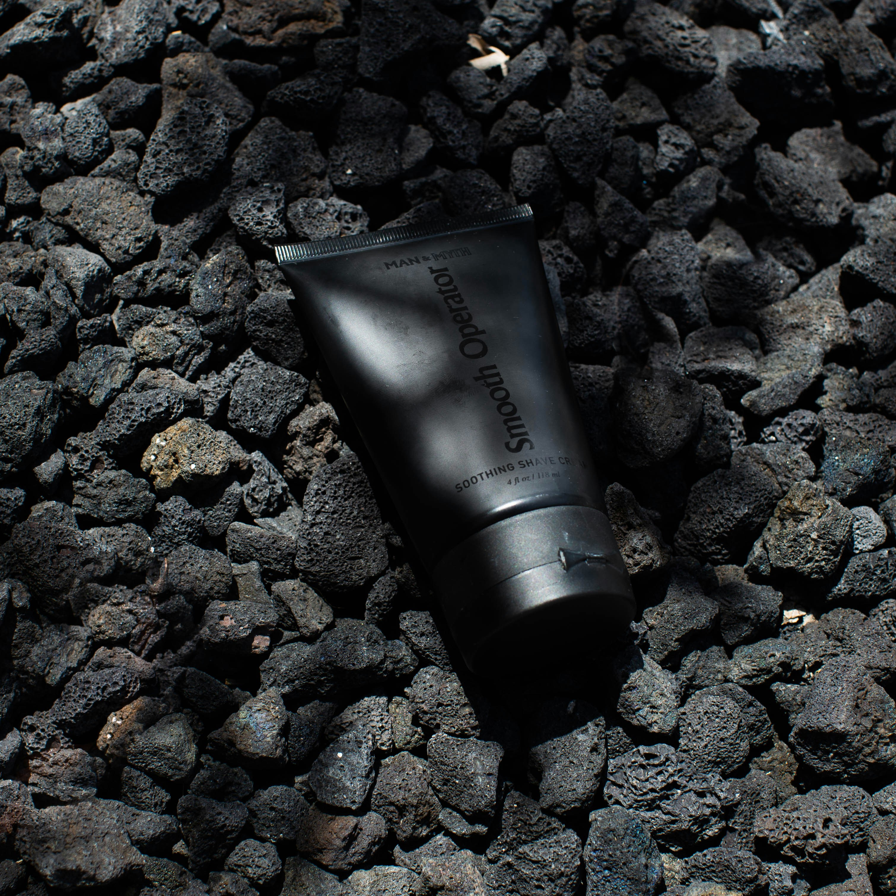 Download Black Tube Bottle On Gray Stones Photo Free Coal Image On Unsplash PSD Mockup Templates