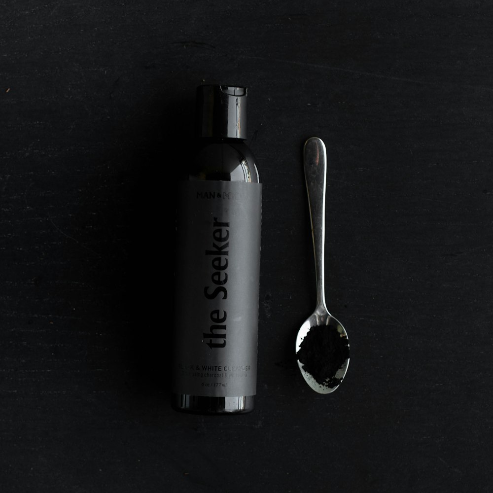 Download Black Tube Bottle On Gray Stones Photo Free Coal Image On Unsplash Yellowimages Mockups