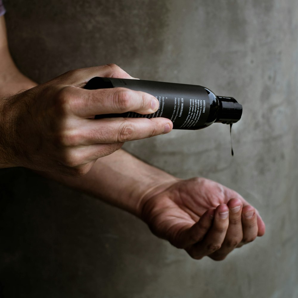 person holding black and silver flashlight