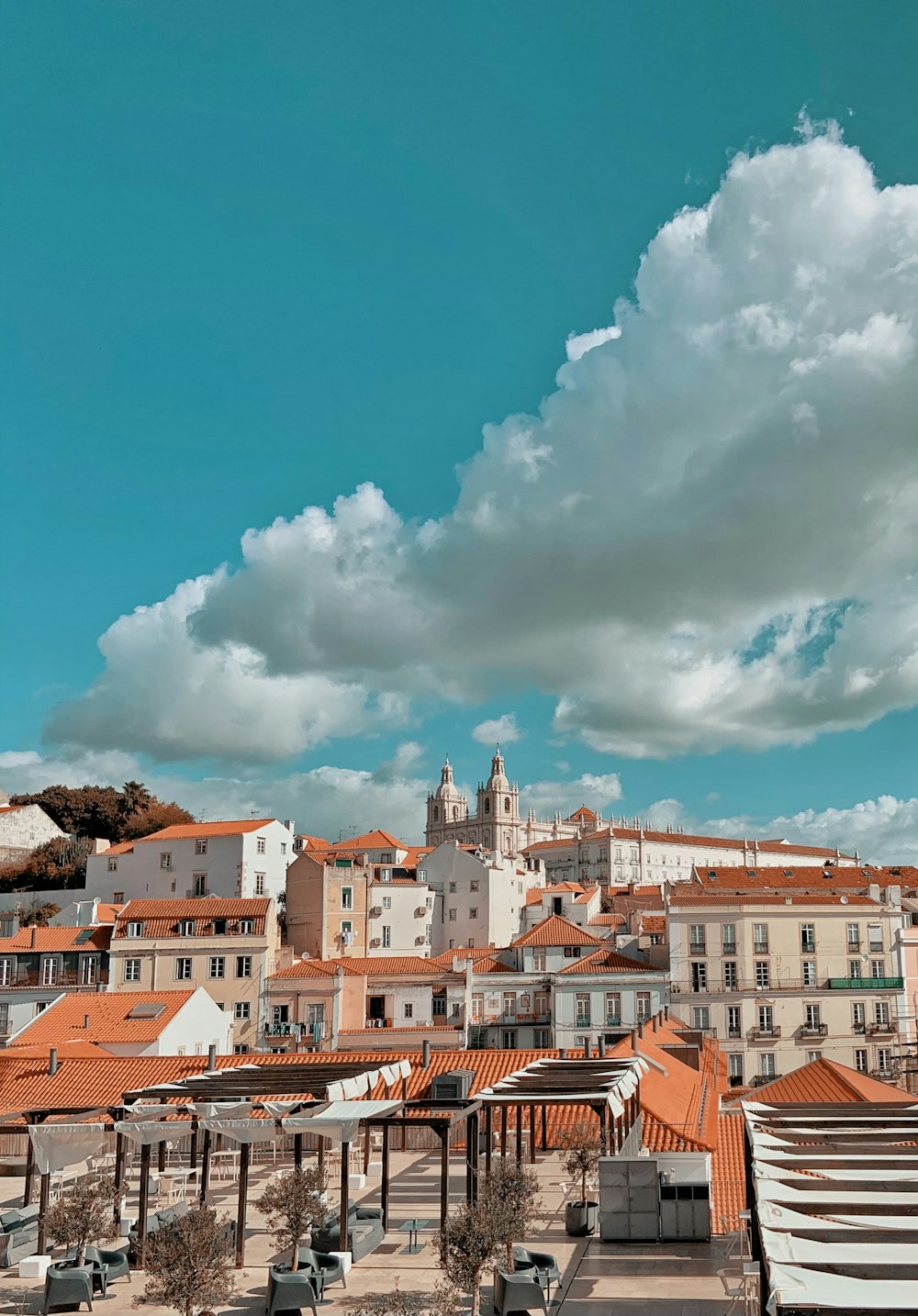 brown and white concrete buildings under blue sky and white clouds during daytime