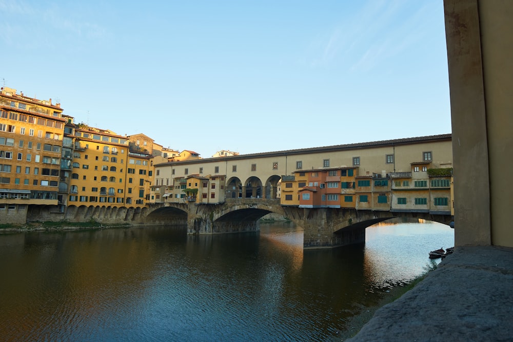 brown concrete bridge over river during daytime