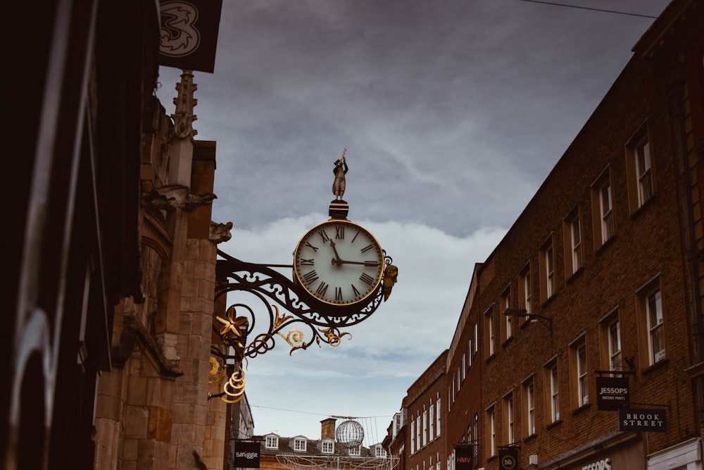 brown concrete building with analog clock