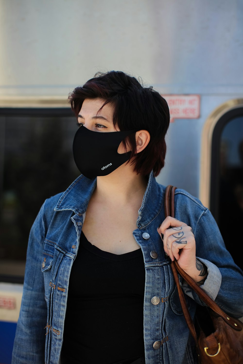 woman in blue denim jacket wearing black sunglasses