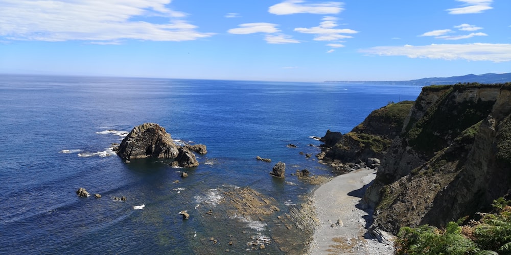 brown rock formation on sea shore during daytime