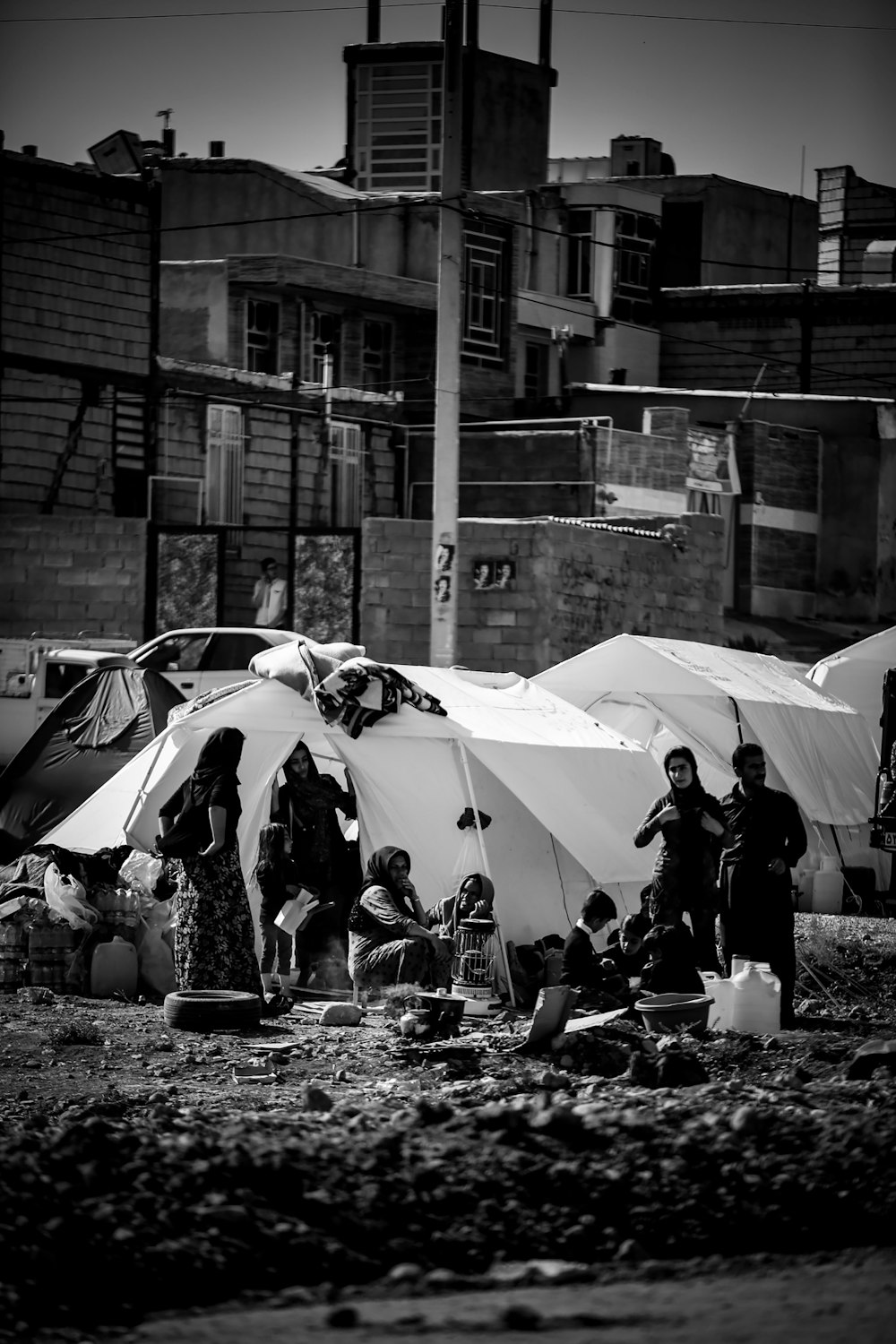 grayscale photo of people in tent