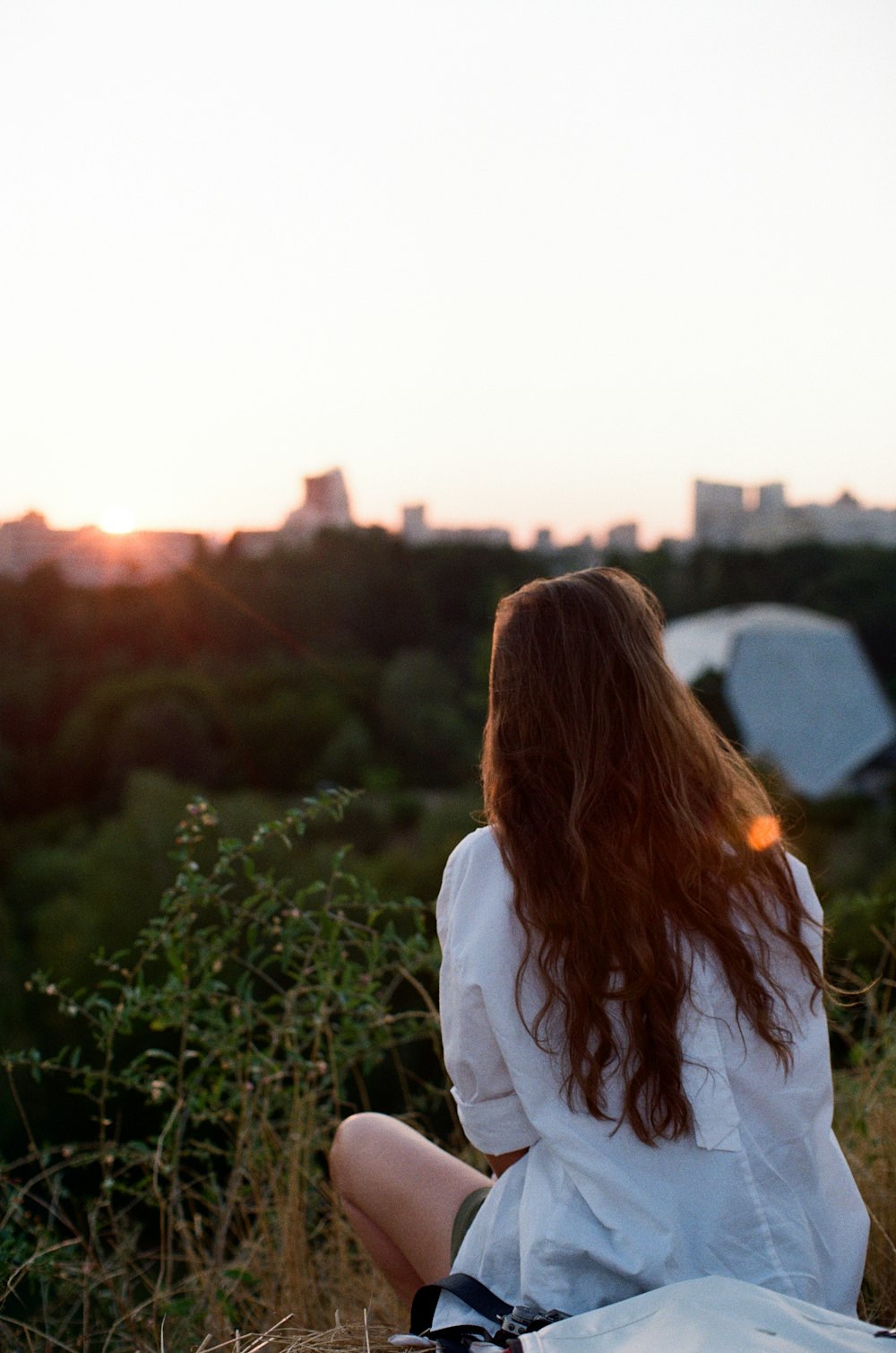 woman in white long sleeve shirt standing on green grass field during daytime