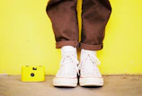 Overhead shot of a sneaker and jacket laid out on a concrete floor.