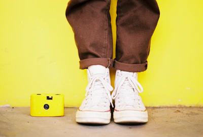 Overhead shot of a sneaker and jacket laid out on a concrete floor.