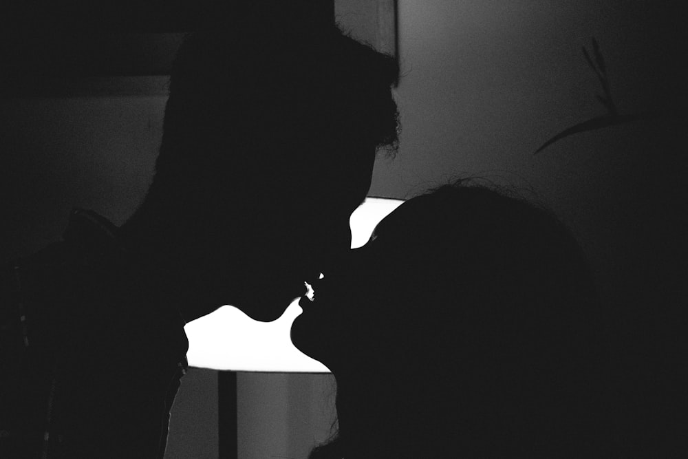 silhouette of man and woman kissing