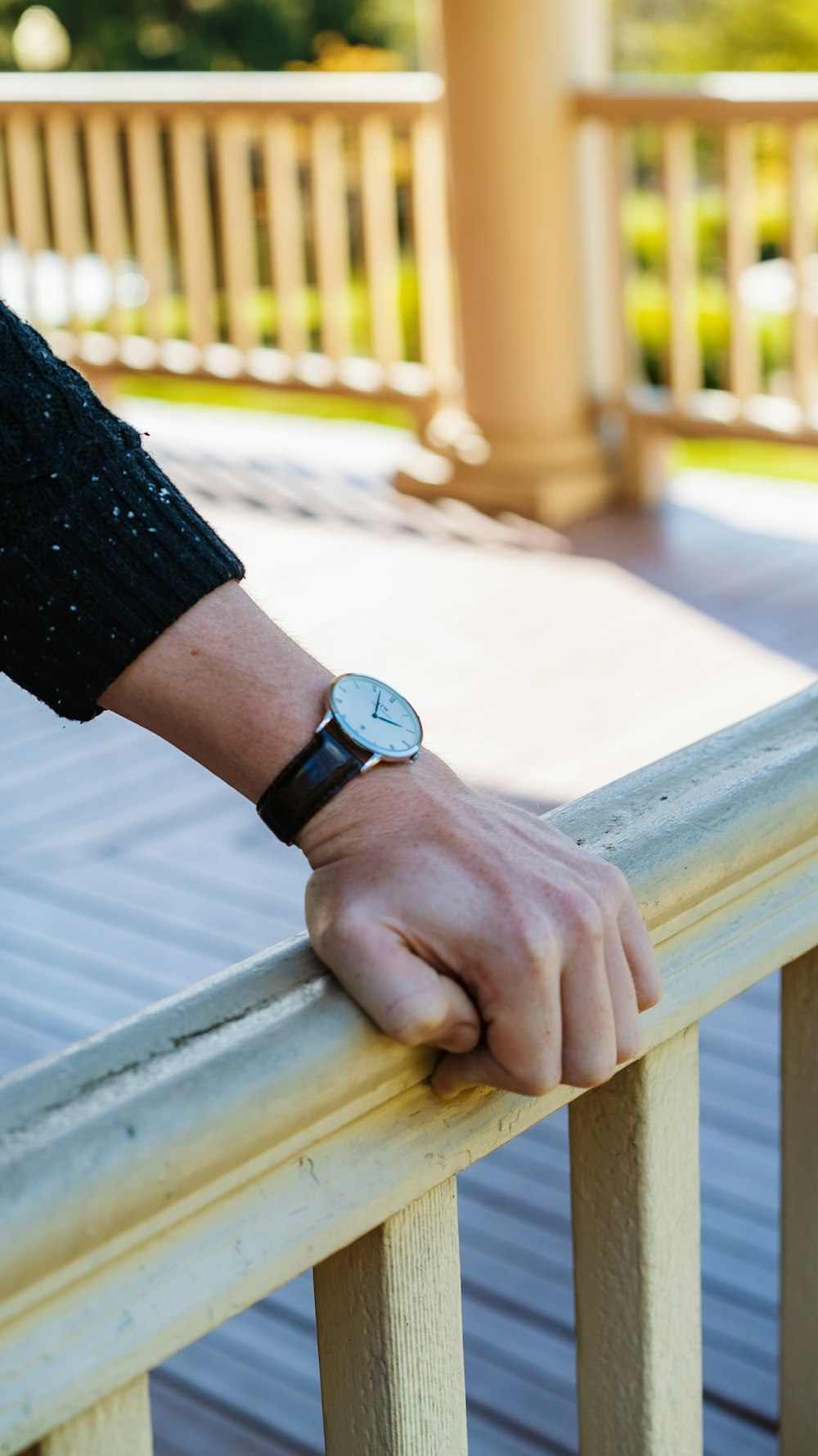 person wearing black watch with black strap