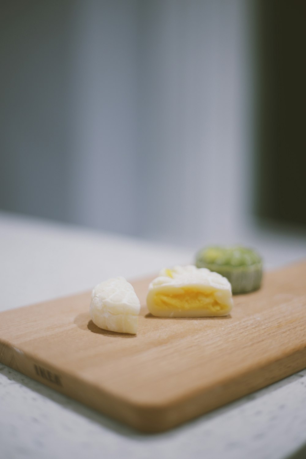 sliced cheese on brown wooden chopping board