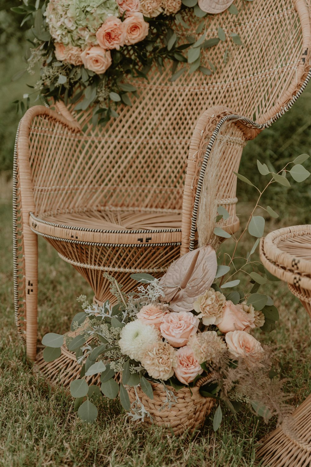 white and pink flowers on brown wicker armchair