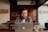 man in black and white plaid dress shirt using silver macbook
