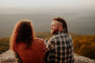 man and woman standing on brown field during daytime