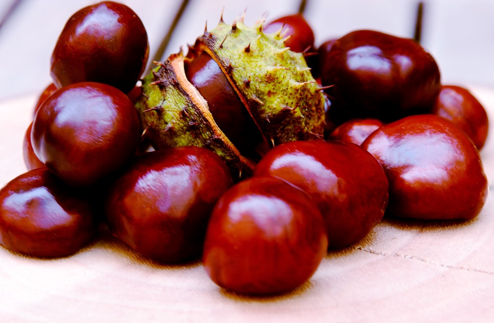 red round fruit on white textile