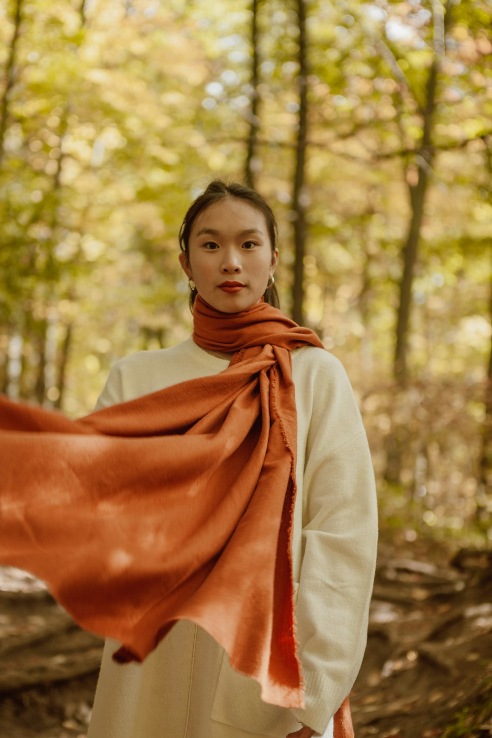 woman in white long sleeve shirt and orange scarf