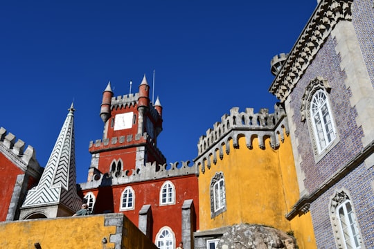 brown and gray concrete building under blue sky during daytime in Sintra-Cascais Natural Park Portugal