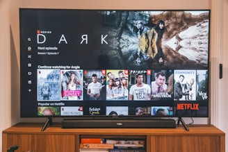 black flat screen tv turned on displaying man in black suit