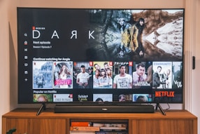 black flat screen tv turned on displaying man in black suit