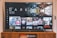 A television screen displaying the Netflix interface is shown. The main focus is the show 'Dark' with a large image from the series. Below it are recommendations for 'Continue Watching,' including shows like 'Selling Sunset,' 'Friends,' and 'Community.' The interface includes the Netflix logo and an array of show thumbnails.