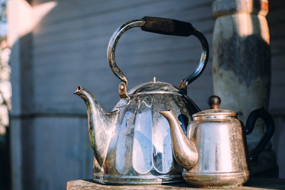 blue and silver teapot on blue table