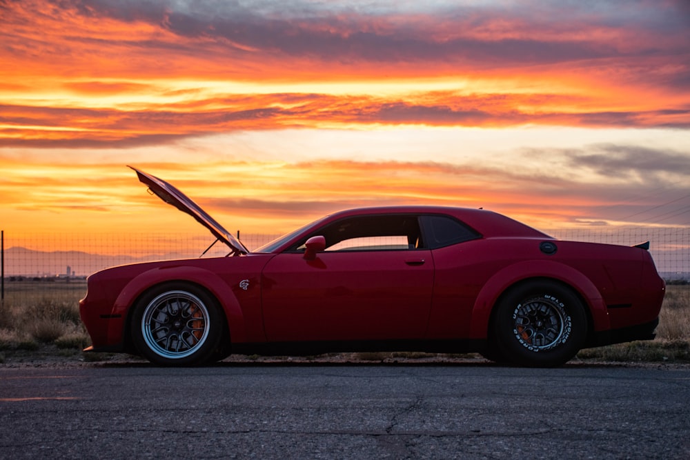 red porsche 911 on road during sunset