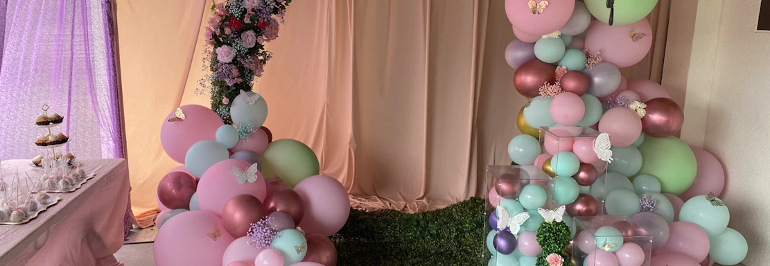 A cheerful balloon arch framing a cozy event space, inviting guests to celebrate.