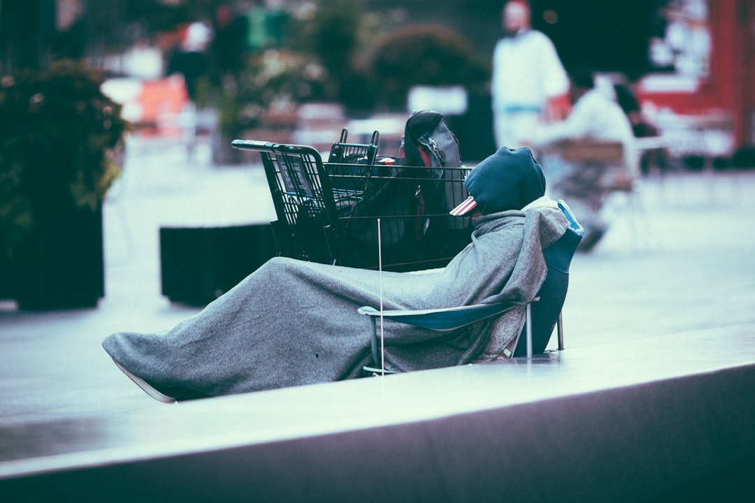 person in blue hoodie sitting on white chair