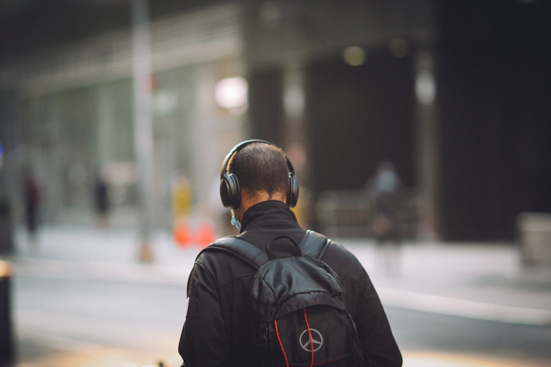 man in black jacket wearing black headphones