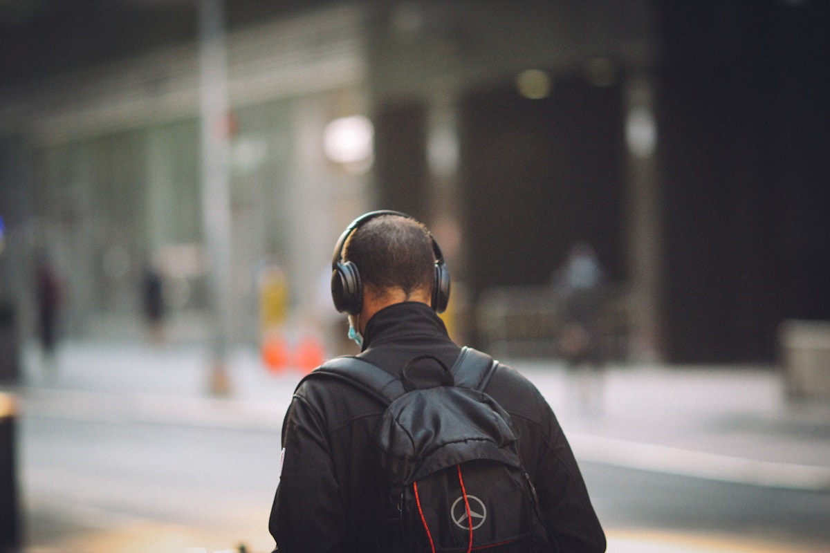 Man in black jacket wearing black headphones