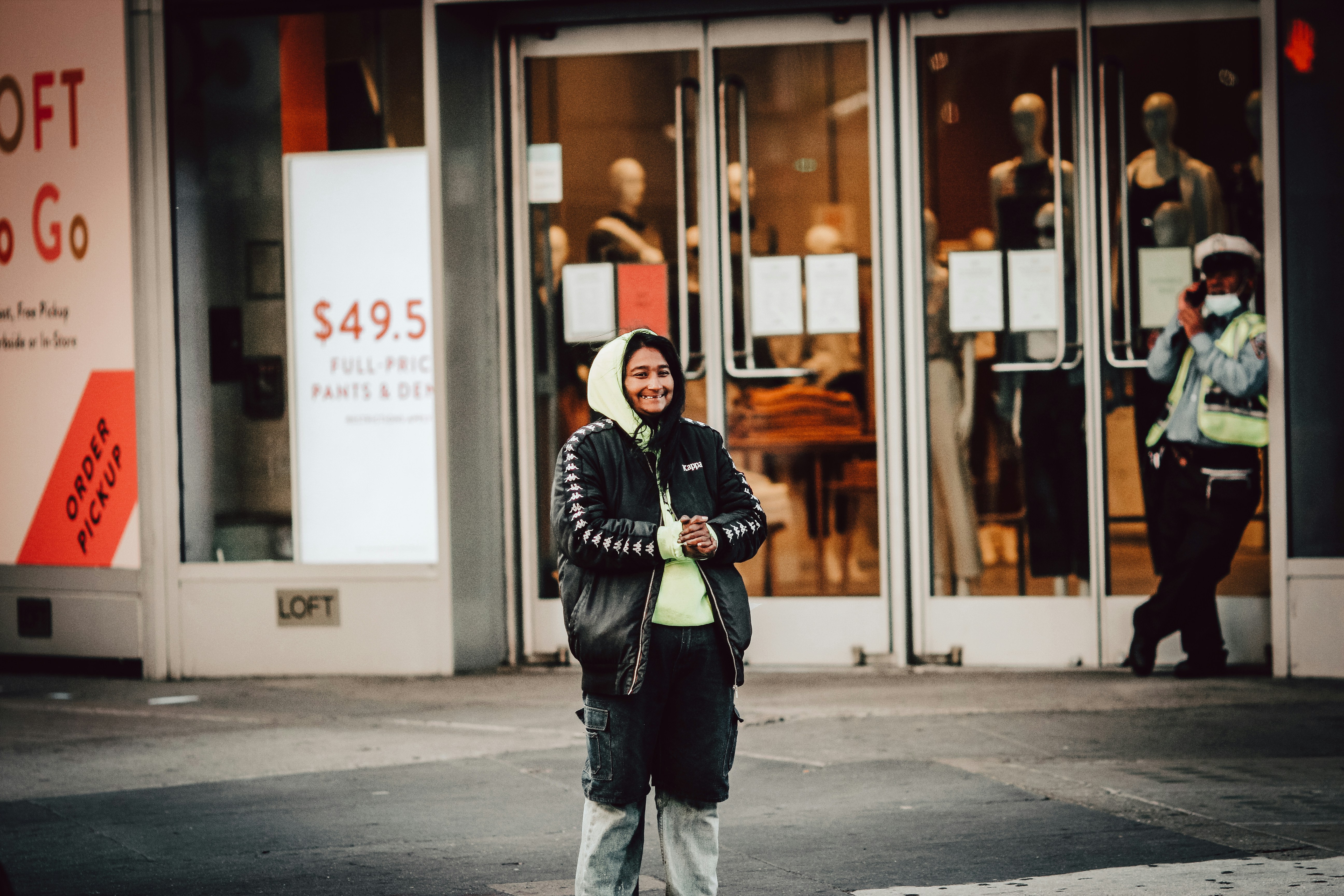 Confident business owner standing in front of their storefront in Orlando, Florida, representing business protection and strategic planning. - key man insurance companies