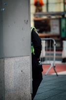 Águas Biones team member in uniform checking water levels on a tanker truck at dawn.