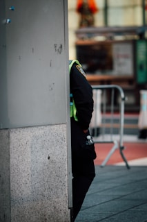 Águas Biones team member in uniform checking water levels on a tanker truck at dawn.