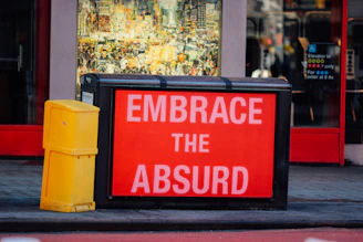 a red sign that says embrace the absurd