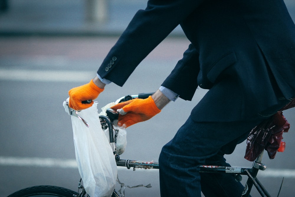 person in black jacket riding on bicycle