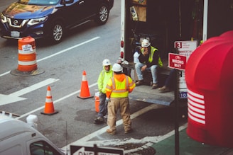 man in green jacket and gray pants walking on pedestrian lane during daytime