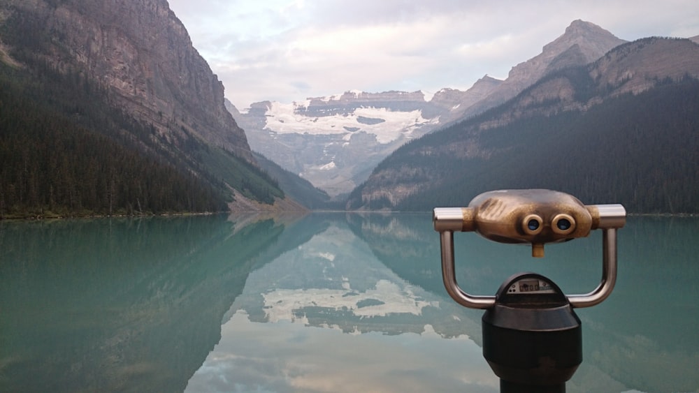 green lake and mountains during daytime