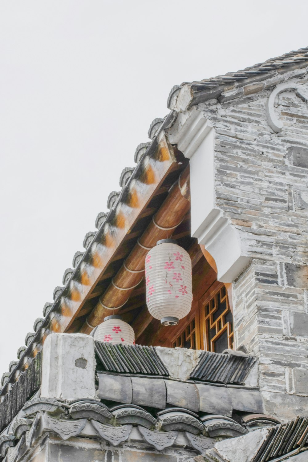 white and pink round ornament on brown wooden roof