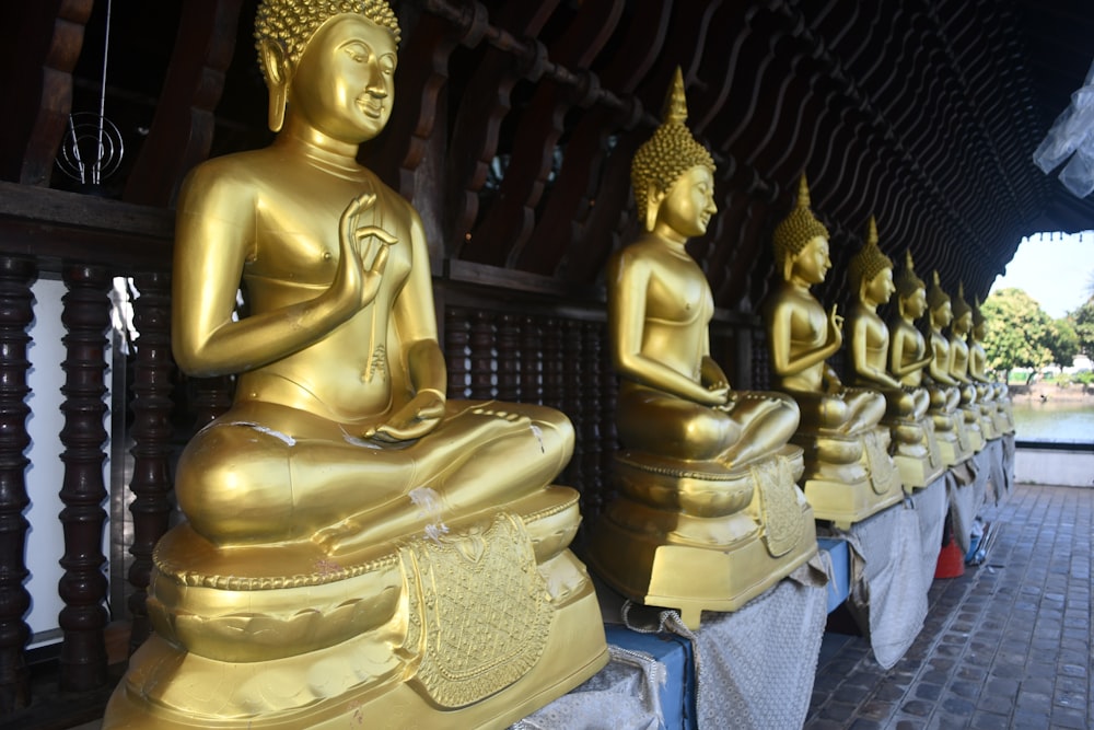 gold buddha statue on blue denim jeans