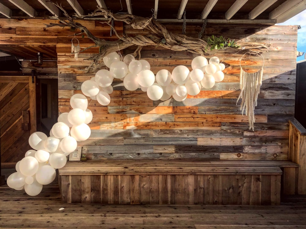 white balloons on brown wooden ceiling