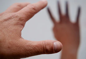persons left hand on white surface