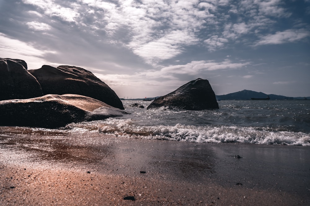 brown rock formation on sea shore during daytime