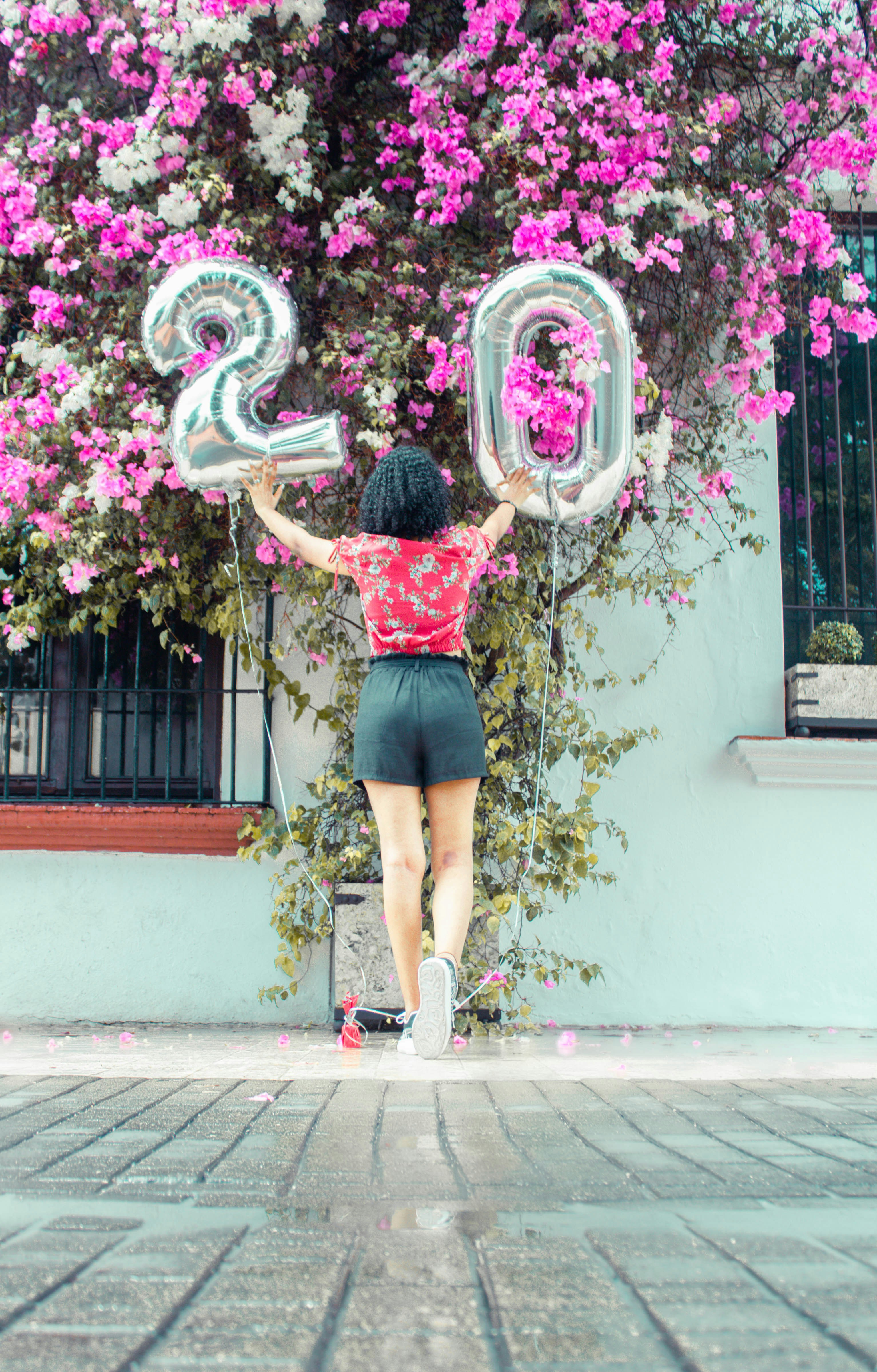 woman in red dress holding heart shaped balloon