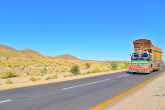 red and yellow truck on road during daytime