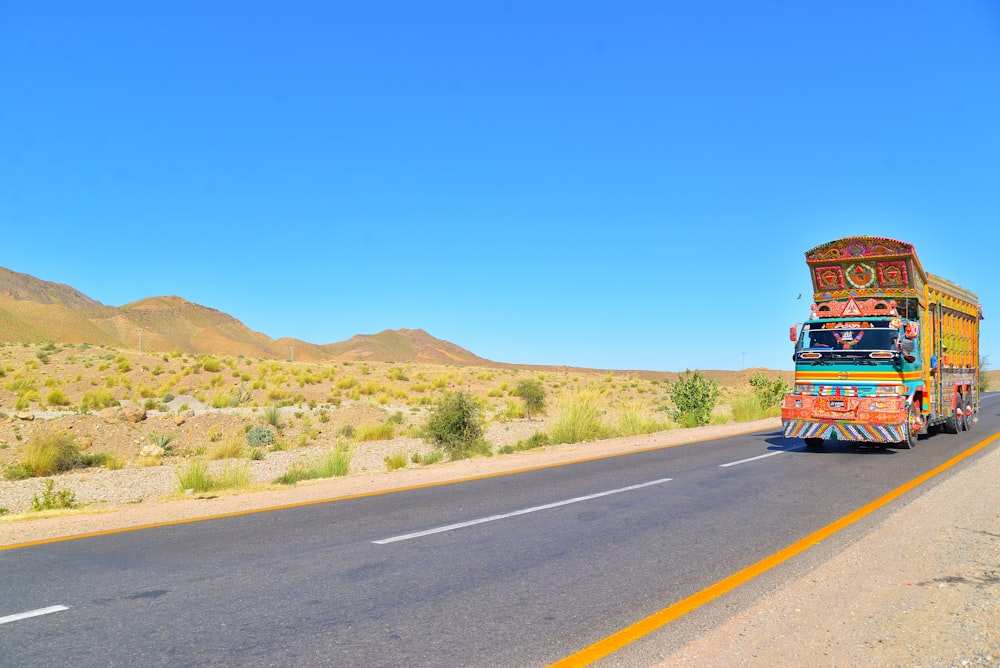 red and yellow truck on road during daytime